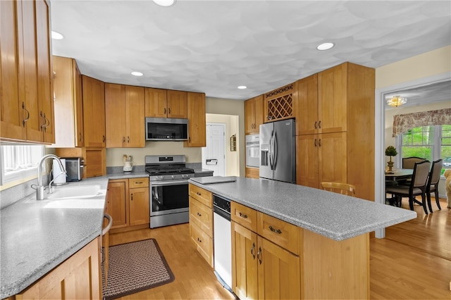195 Deer Ridge Dr, North Kingstown, RI 02874 - kitchen with stainless steel appliances, a sink, a kitchen island, light wood finished floors, and recessed lighting