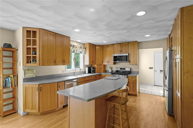 195 Deer Ridge Dr, North Kingstown, RI 02874 - kitchen featuring stainless steel appliances, a breakfast bar area, a center island, light wood finished floors, and recessed lighting