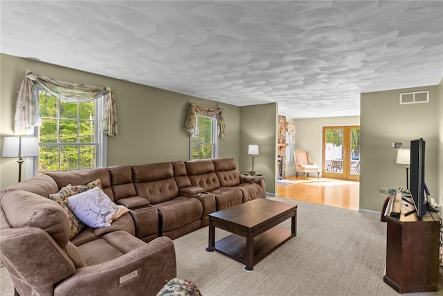 195 Deer Ridge Dr, North Kingstown, RI 02874 - living area with french doors, carpet floors, baseboards, and a textured ceiling