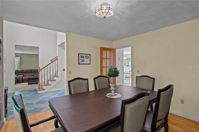 195 Deer Ridge Dr, North Kingstown, RI 02874 - dining room featuring light wood-style floors, stairs, and baseboards