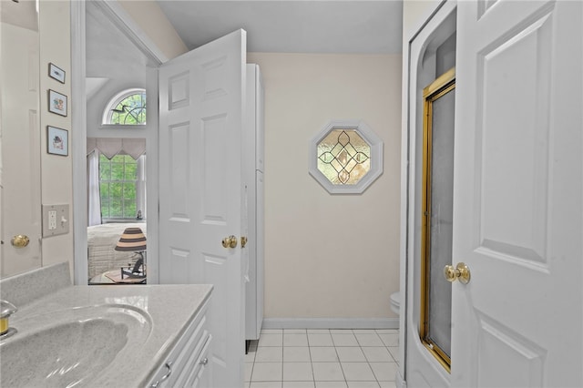 195 Deer Ridge Dr, North Kingstown, RI 02874 - full bath with tile patterned floors, vanity, toilet, baseboards, and an enclosed shower