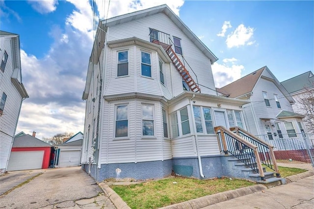 184 Wadsworth St, Providence, RI 02909 - view of front of house with a garage and an outbuilding