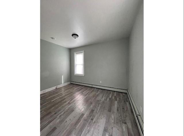 184 Wadsworth St, Providence, RI 02909 - empty room featuring baseboard heating, wood finished floors, and baseboards