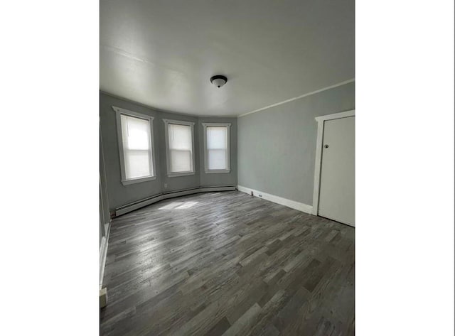 184 Wadsworth St, Providence, RI 02909 - spare room featuring dark wood finished floors, baseboards, and a baseboard heating unit