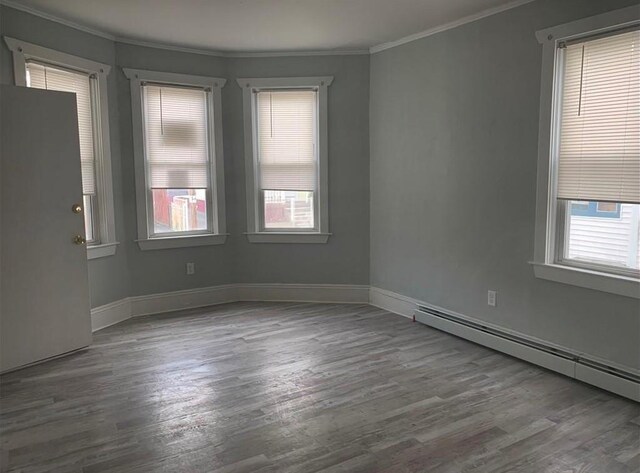 184 Wadsworth St, Providence, RI 02909 - unfurnished room with ornamental molding, a baseboard heating unit, wood finished floors, and baseboards