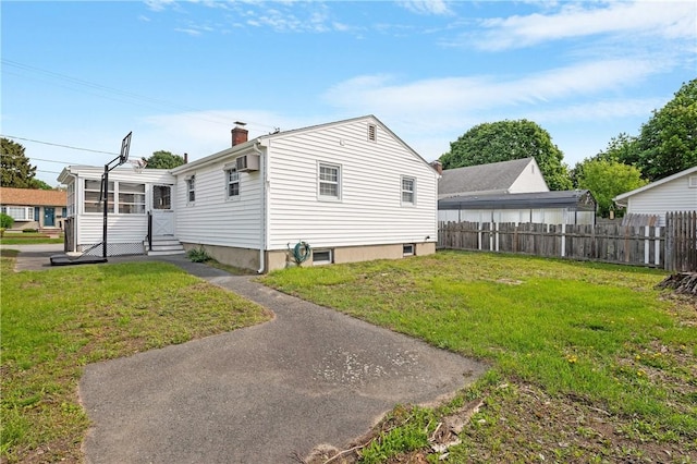 view of side of home featuring entry steps, a chimney, and a wall unit AC