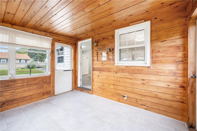 spare room featuring wood walls, wooden ceiling, and tile patterned floors
