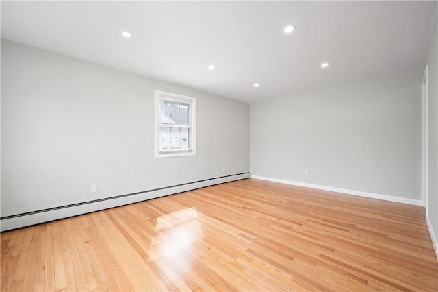 unfurnished room with a baseboard radiator, light wood-style floors, recessed lighting, and baseboards