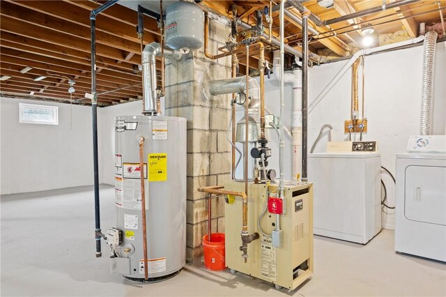 basement featuring water heater, washer and dryer, and a heating unit