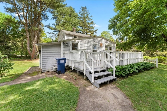 18 W St, Hopkinton, RI 02804 - view of home's exterior featuring a deck, a yard, and a chimney