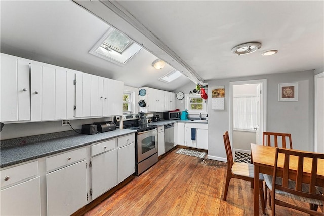 18 W St, Hopkinton, RI 02804 - kitchen with appliances with stainless steel finishes, a skylight, a sink, wood finished floors, and white cabinets