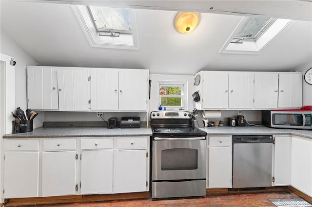 18 W St, Hopkinton, RI 02804 - kitchen featuring stainless steel appliances, white cabinets, dark wood finished floors, a skylight, and light countertops