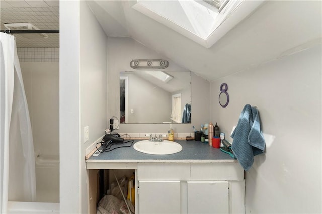 18 W St, Hopkinton, RI 02804 - bathroom with vaulted ceiling, vanity, a shower with shower curtain, and a skylight