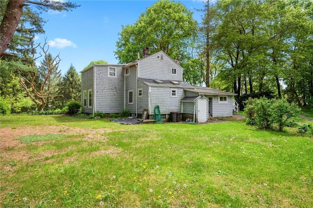 18 W St, Hopkinton, RI 02804 - rear view of house with a lawn, a chimney, an outbuilding, and a storage shed
