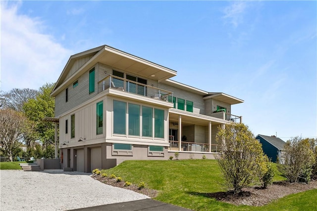 82 Ellery Rd, Newport, RI 02840 - view of front of home featuring a balcony, a front lawn, a garage, and board and batten siding