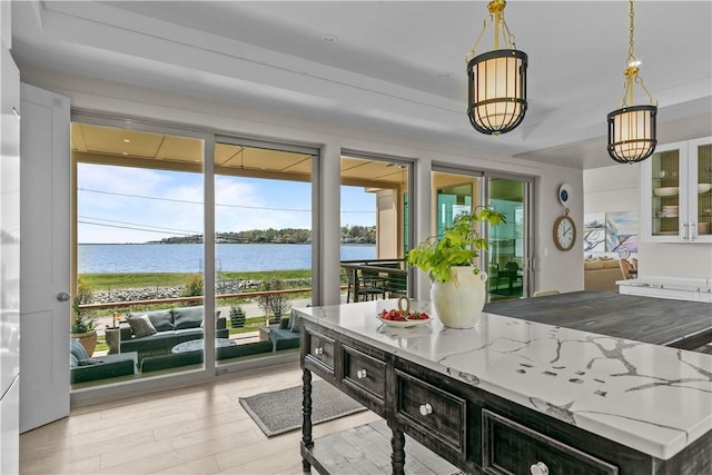 82 Ellery Rd, Newport, RI 02840 - kitchen featuring plenty of natural light, light wood-style flooring, a water view, and hanging light fixtures