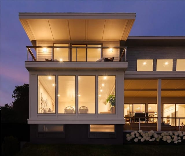 82 Ellery Rd, Newport, RI 02840 - back of house at twilight featuring a balcony