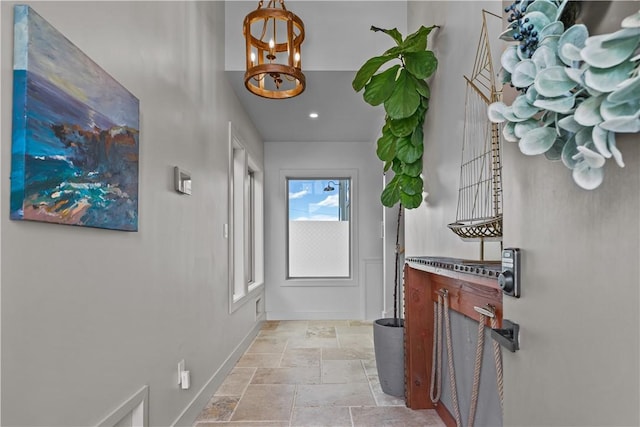 82 Ellery Rd, Newport, RI 02840 - hallway with stone tile flooring, a chandelier, baseboards, and recessed lighting