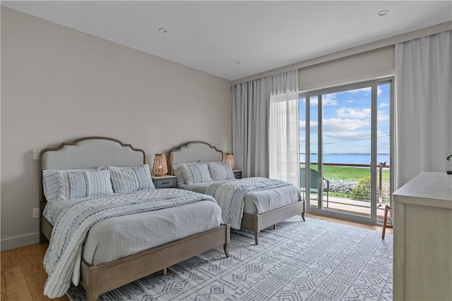 82 Ellery Rd, Newport, RI 02840 - bedroom with access to exterior, light wood-style floors, a water view, and baseboards