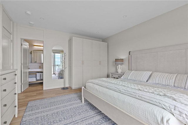 82 Ellery Rd, Newport, RI 02840 - bedroom with light wood-style floors and arched walkways
