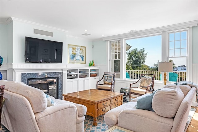 112 Avondale Rd, Westerly, RI 02891 - living room featuring crown molding, a high end fireplace, wainscoting, and a decorative wall