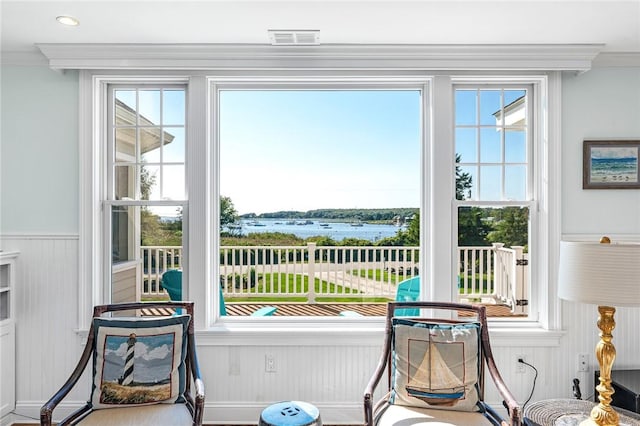 112 Avondale Rd, Westerly, RI 02891 - doorway featuring ornamental molding, plenty of natural light, wainscoting, and wooden walls
