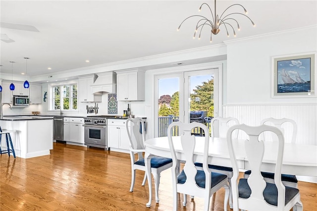 112 Avondale Rd, Westerly, RI 02891 - dining space featuring crown molding, light wood-style floors, and a chandelier