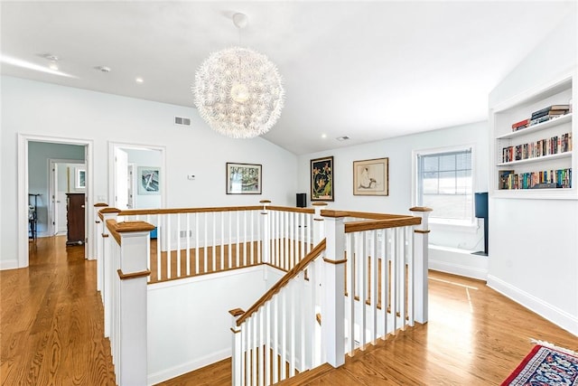112 Avondale Rd, Westerly, RI 02891 - corridor with an upstairs landing, wood finished floors, baseboards, vaulted ceiling, and recessed lighting