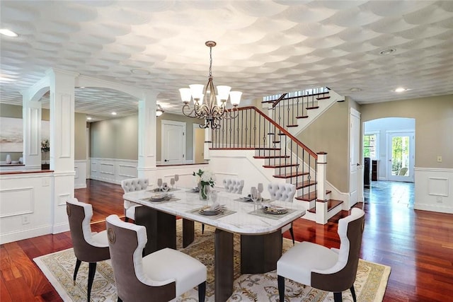 26 Old Richmond Townhouse Rd, Richmond, RI 02812 - dining area featuring a decorative wall, stairway, wood finished floors, wainscoting, and a chandelier