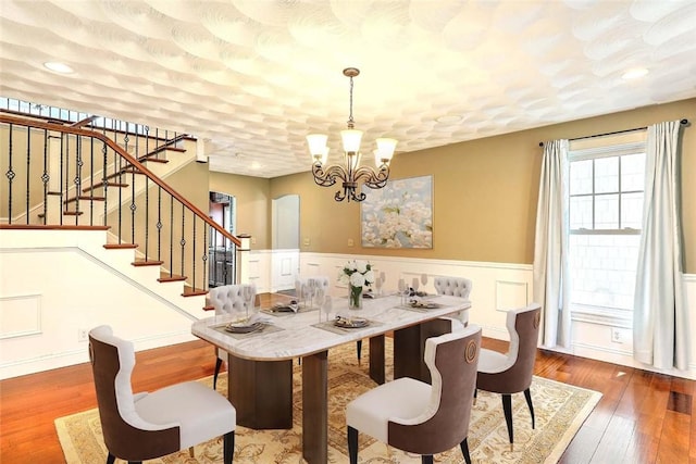 26 Old Richmond Townhouse Rd, Richmond, RI 02812 - dining room with stairway, a chandelier, a wainscoted wall, and wood finished floors