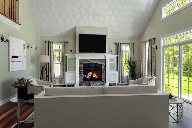 26 Old Richmond Townhouse Rd, Richmond, RI 02812 - living area with wood finished floors, high vaulted ceiling, a stone fireplace, and baseboards