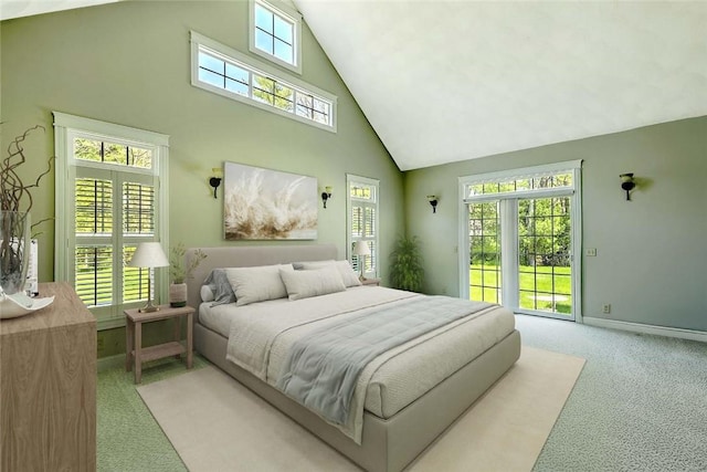 26 Old Richmond Townhouse Rd, Richmond, RI 02812 - bedroom with high vaulted ceiling, light carpet, access to exterior, and baseboards