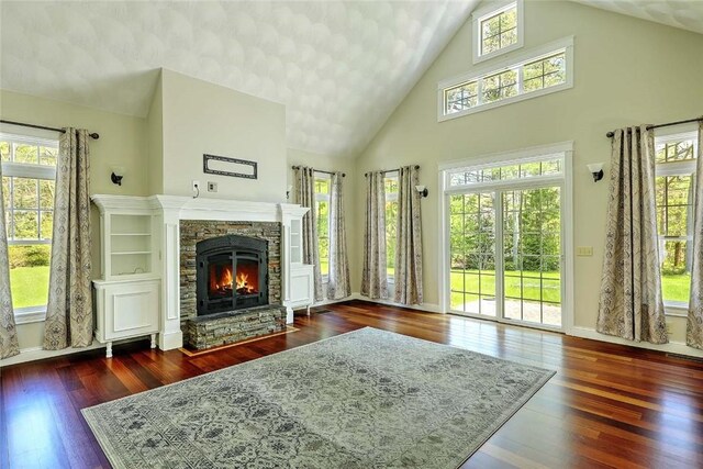 26 Old Richmond Townhouse Rd, Richmond, RI 02812 - living area featuring a fireplace, high vaulted ceiling, wood-type flooring, and baseboards