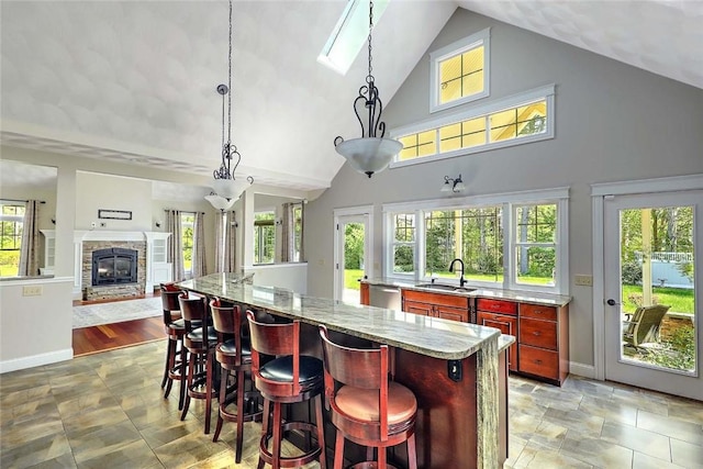 26 Old Richmond Townhouse Rd, Richmond, RI 02812 - kitchen with reddish brown cabinets, high vaulted ceiling, a sink, open floor plan, and dishwasher