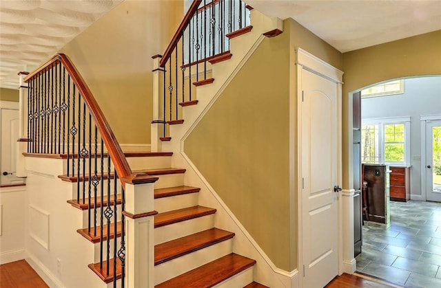 26 Old Richmond Townhouse Rd, Richmond, RI 02812 - staircase featuring arched walkways, baseboards, and wood finished floors