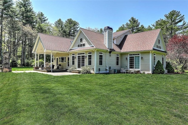 26 Old Richmond Townhouse Rd, Richmond, RI 02812 - back of house with a lawn, a chimney, a patio area, cooling unit, and a shingled roof