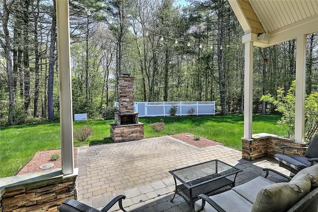 26 Old Richmond Townhouse Rd, Richmond, RI 02812 - view of patio featuring an outdoor stone fireplace and a forest view