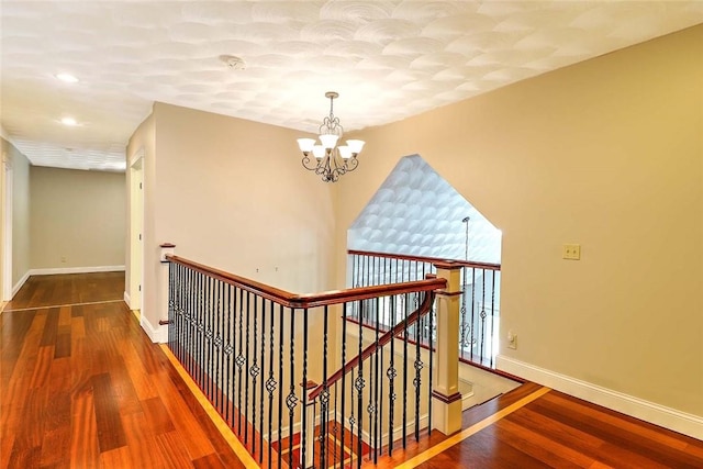 26 Old Richmond Townhouse Rd, Richmond, RI 02812 - hallway with an upstairs landing, a chandelier, wood finished floors, baseboards, and recessed lighting