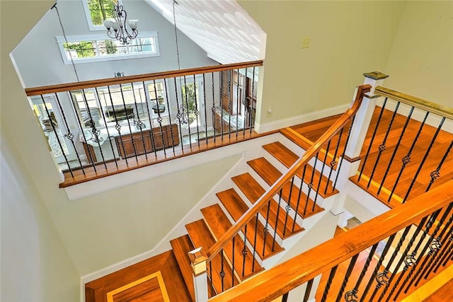 26 Old Richmond Townhouse Rd, Richmond, RI 02812 - staircase featuring high vaulted ceiling, a chandelier, and baseboards