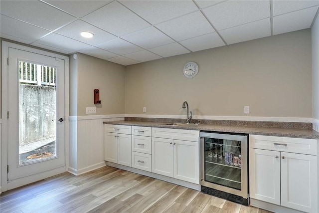 26 Old Richmond Townhouse Rd, Richmond, RI 02812 - indoor bar featuring wine cooler, a wainscoted wall, a drop ceiling, and light wood-style floors