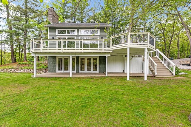 12 Hazel Point Rd, Smithfield, RI 02917 - back of property featuring a chimney, a yard, a wooden deck, stairs, and a patio area