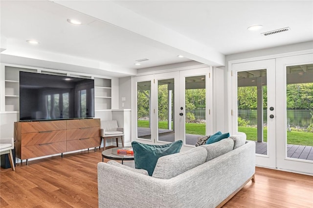 12 Hazel Point Rd, Smithfield, RI 02917 - living area featuring french doors, healthy amount of natural light, wood finished floors, recessed lighting, and built in shelves