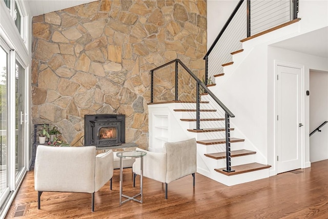 12 Hazel Point Rd, Smithfield, RI 02917 - living room with wood finished floors, stairs, a fireplace, and a towering ceiling