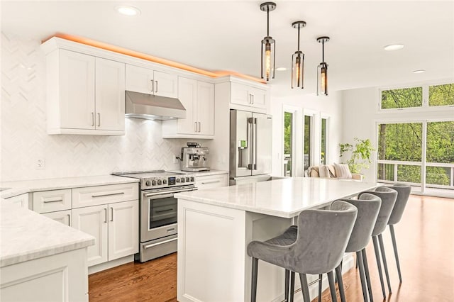 12 Hazel Point Rd, Smithfield, RI 02917 - kitchen with appliances with stainless steel finishes, under cabinet range hood, plenty of natural light, a breakfast bar, and recessed lighting