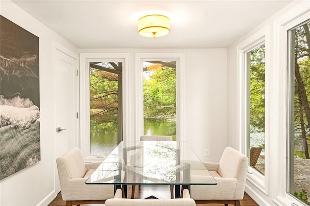 12 Hazel Point Rd, Smithfield, RI 02917 - dining area featuring healthy amount of natural light, dark wood finished floors, and a water view