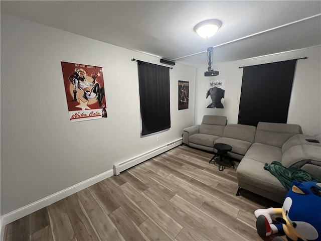 living room with baseboard heating, wood finished floors, and baseboards