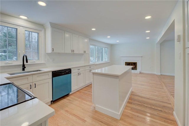 247 Quaker Ln, Scituate, RI 02857 - kitchen featuring dishwashing machine, a sink, white cabinetry, light wood-style floors, and recessed lighting
