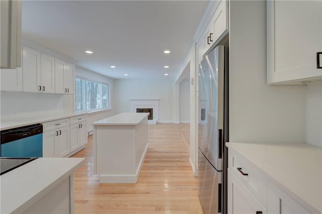 247 Quaker Ln, Scituate, RI 02857 - kitchen featuring stainless steel fridge with ice dispenser, dishwashing machine, light wood-style flooring, white cabinetry, and recessed lighting