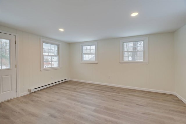 247 Quaker Ln, Scituate, RI 02857 - basement with a baseboard heating unit, light wood-type flooring, baseboards, and recessed lighting