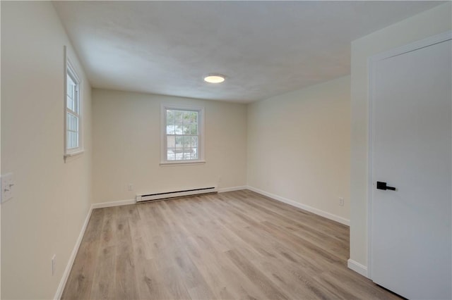 247 Quaker Ln, Scituate, RI 02857 - empty room with a baseboard radiator, light wood-style flooring, and baseboards